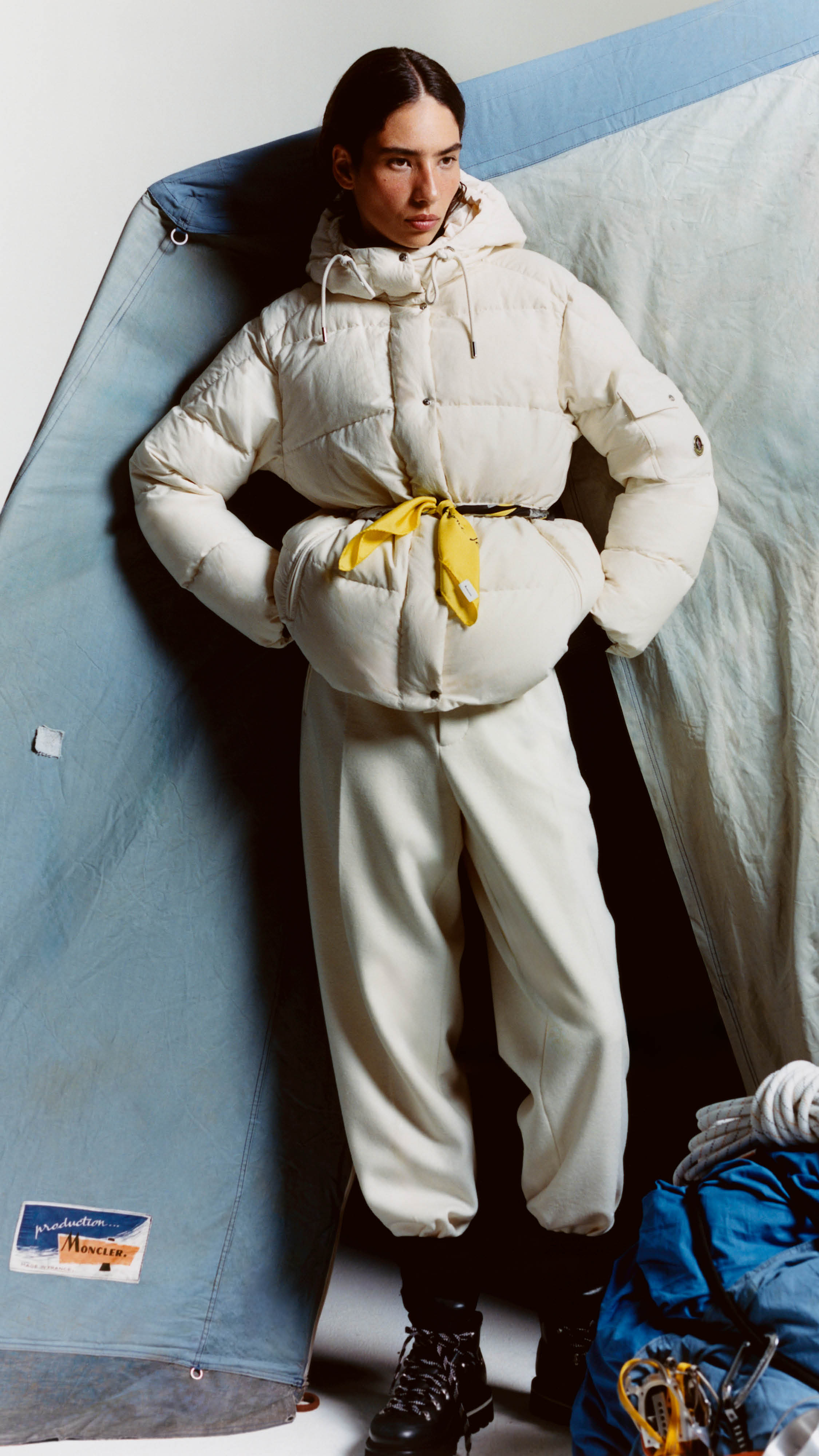 Moncler Re/Icons 2026, cream Himalaya down jacket belted with a yellow scarf.