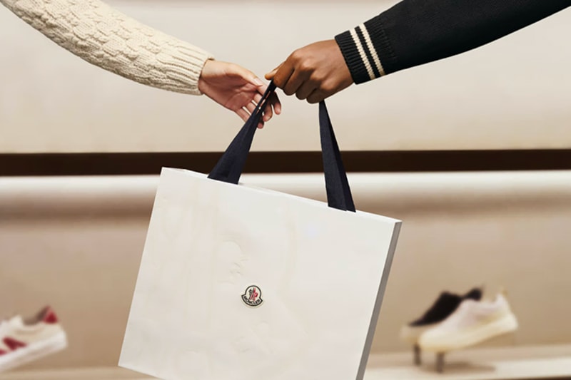A customer returning an item in a Moncler boutique, illustrating the exchange and return service.