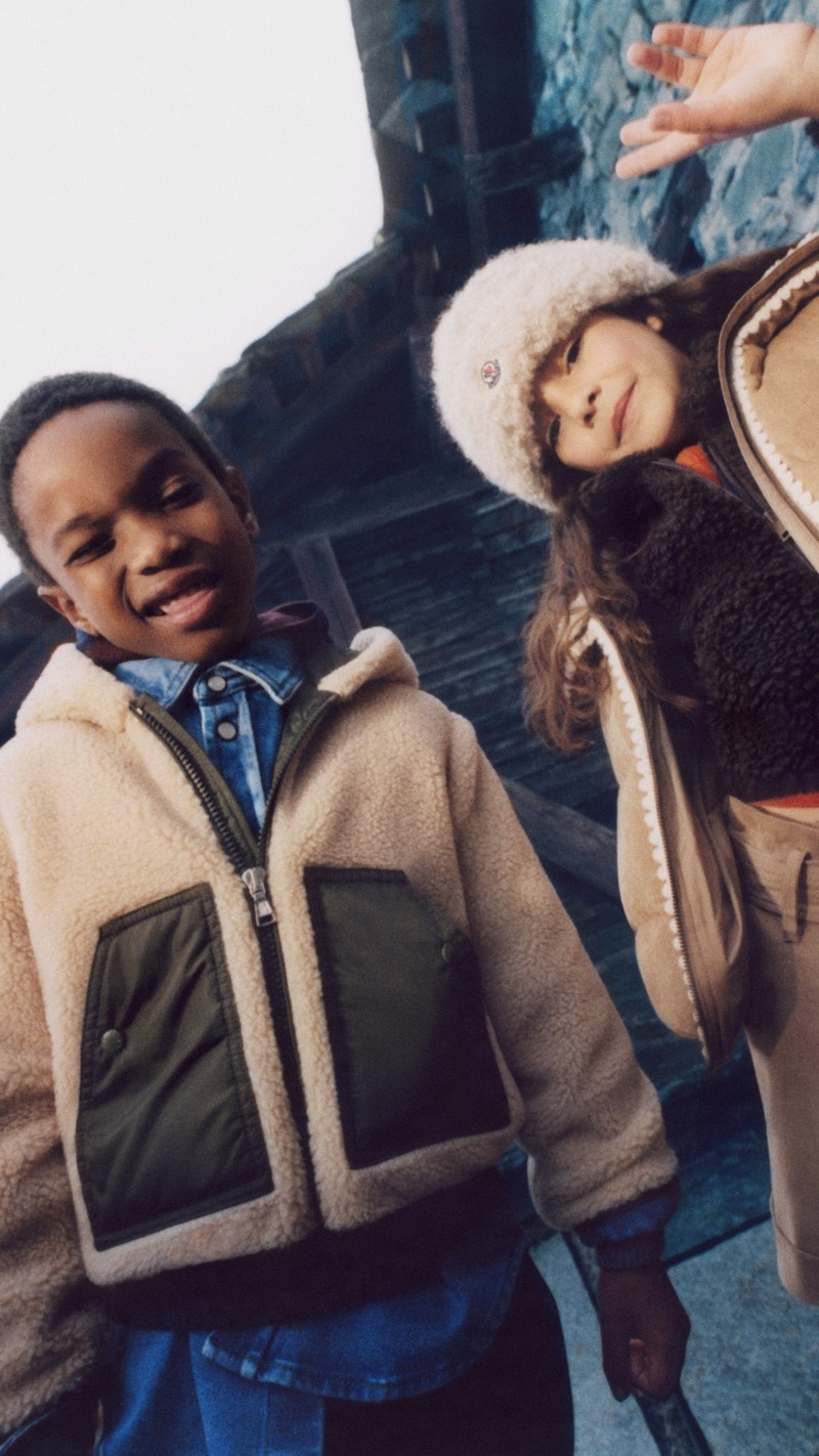 Moncler for Children Fall/Winter 2026. Shearling jackets, denim shirt, dark sweatshirt and fluffy white hat.