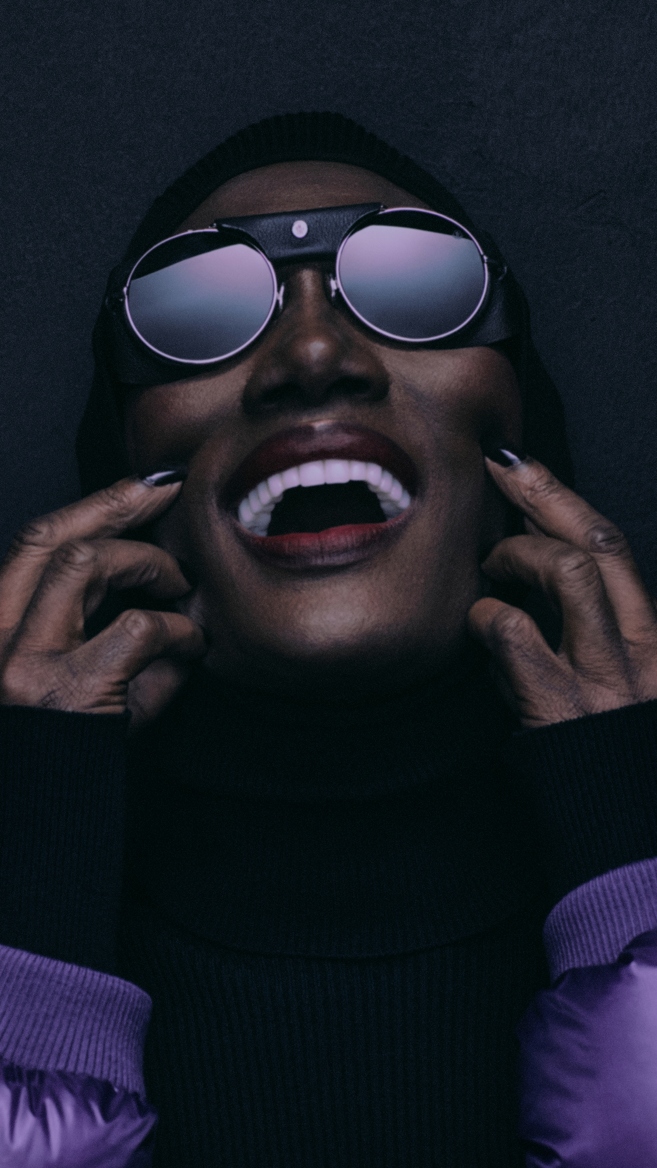 Moncler Re/Icons 2026, behind the scenes in black and white: Grace Jones in a glossy down jacket with the cast. 