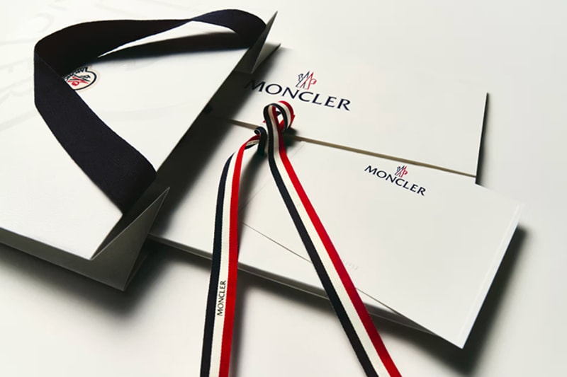 Moncler gift boxes and envelopes with tricolor and black ribbons.
