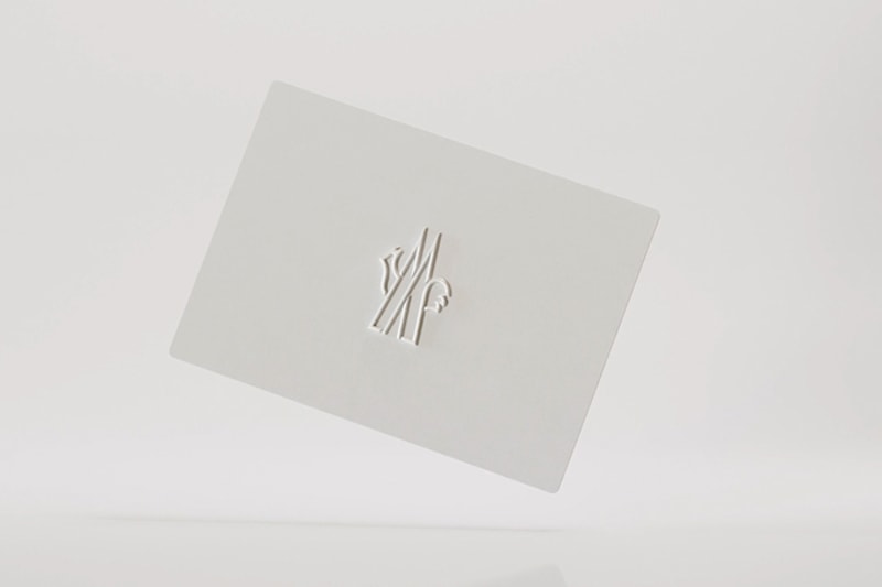 White Moncler gift card with embossed logo on a light background.