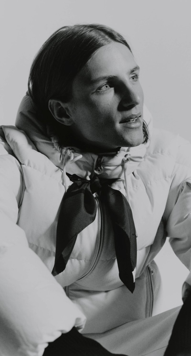 Moncler Re/Icons 2026, Himalaya. Camel down jacket and red balaclava, blue climbing rope.