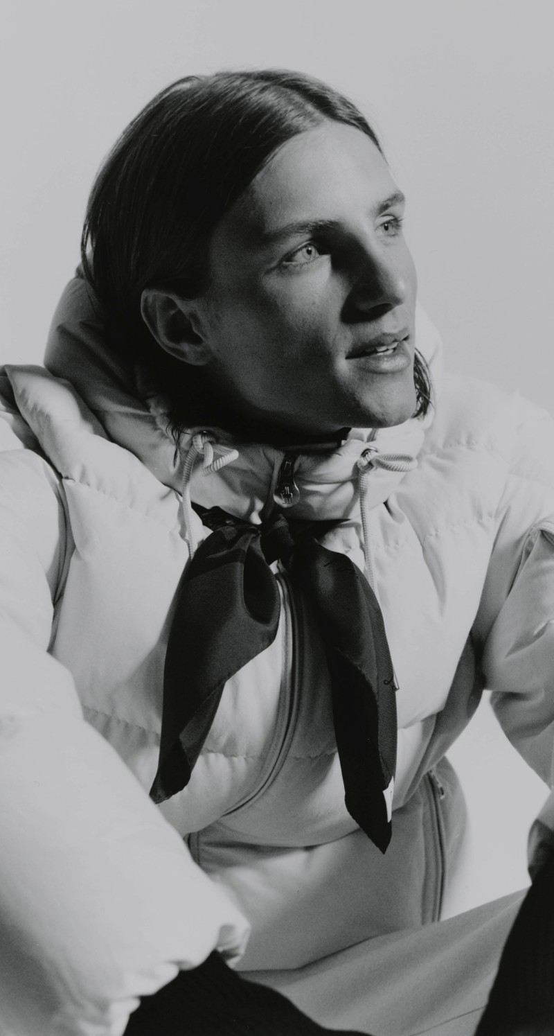 Moncler Re/Icons 2026, Himalaya. Camel down jacket and red balaclava, blue climbing rope.