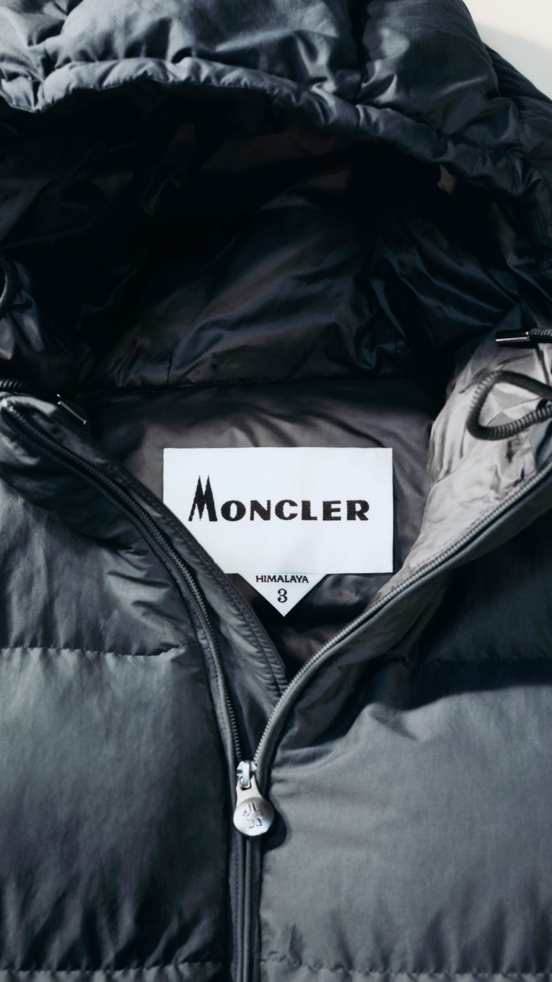 Moncler Re/Icons 2026, black Himalaya down jacket with the Moncler Himalaya label inside the collar.