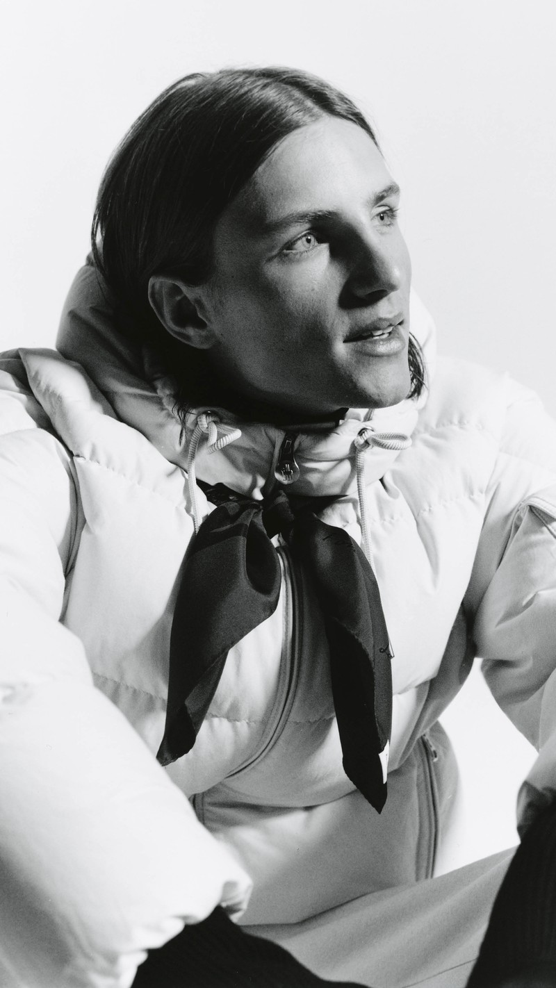 Moncler Re/Icons 2026, black and white portrait, light Himalaya down jacket and a knotted scarf.