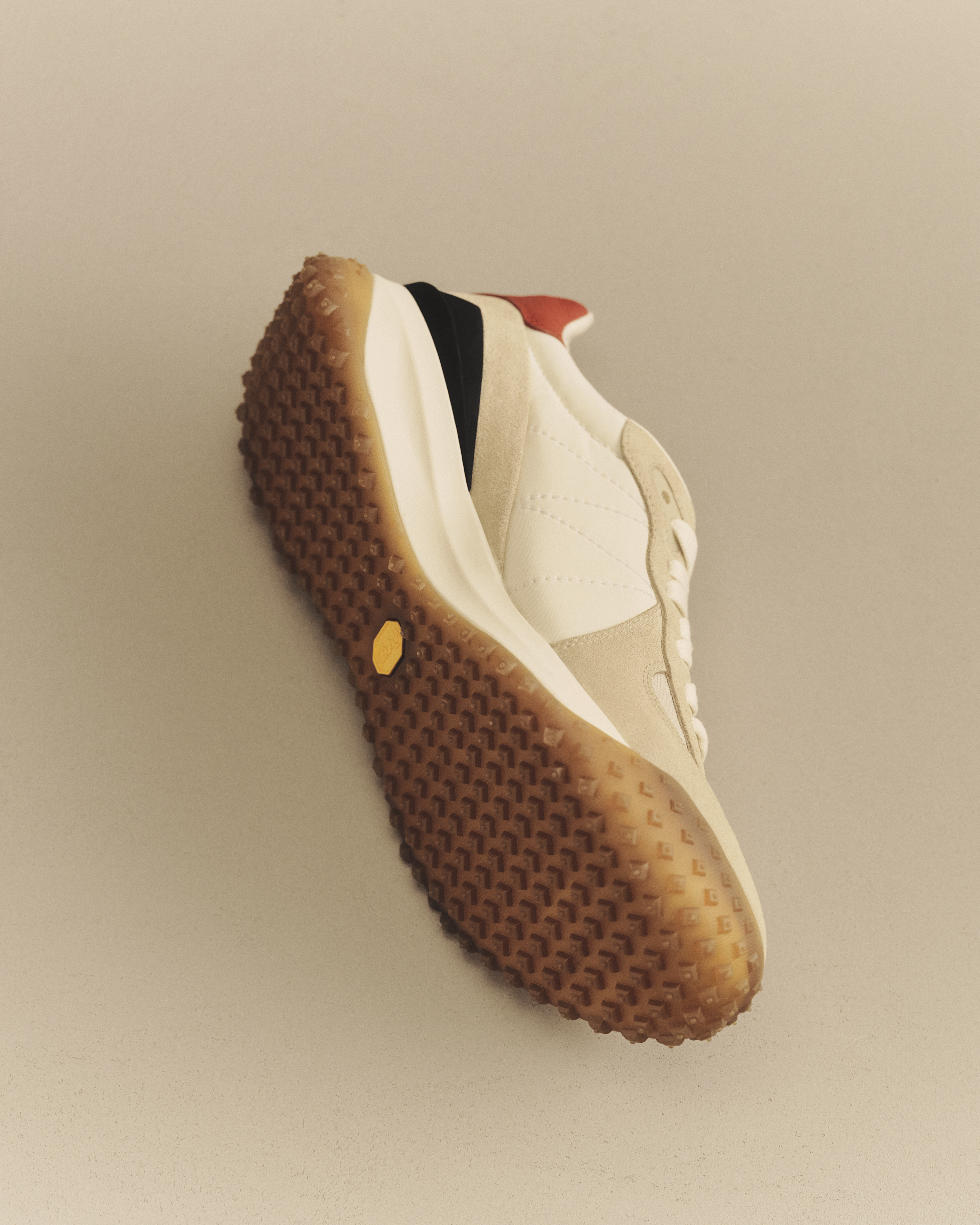 Moncler CityTrek: beige and white sneaker with black and red details and rubber sole.