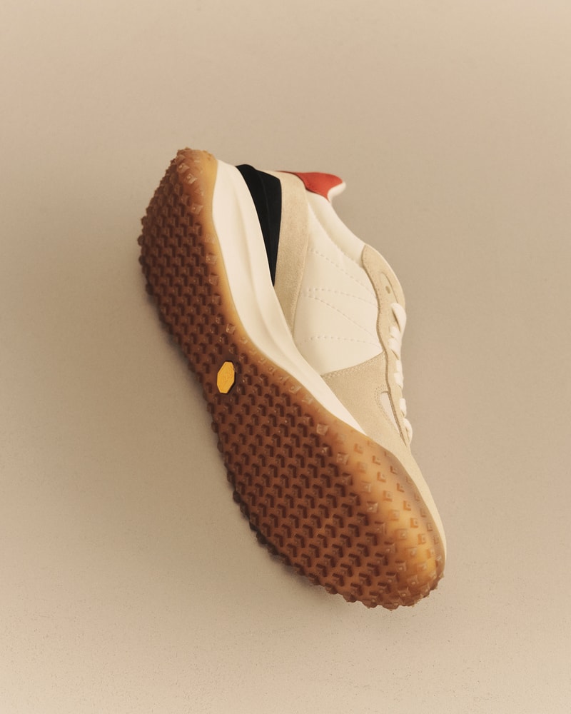 Moncler CityTrek: beige and white sneaker with black and red details and rubber sole.