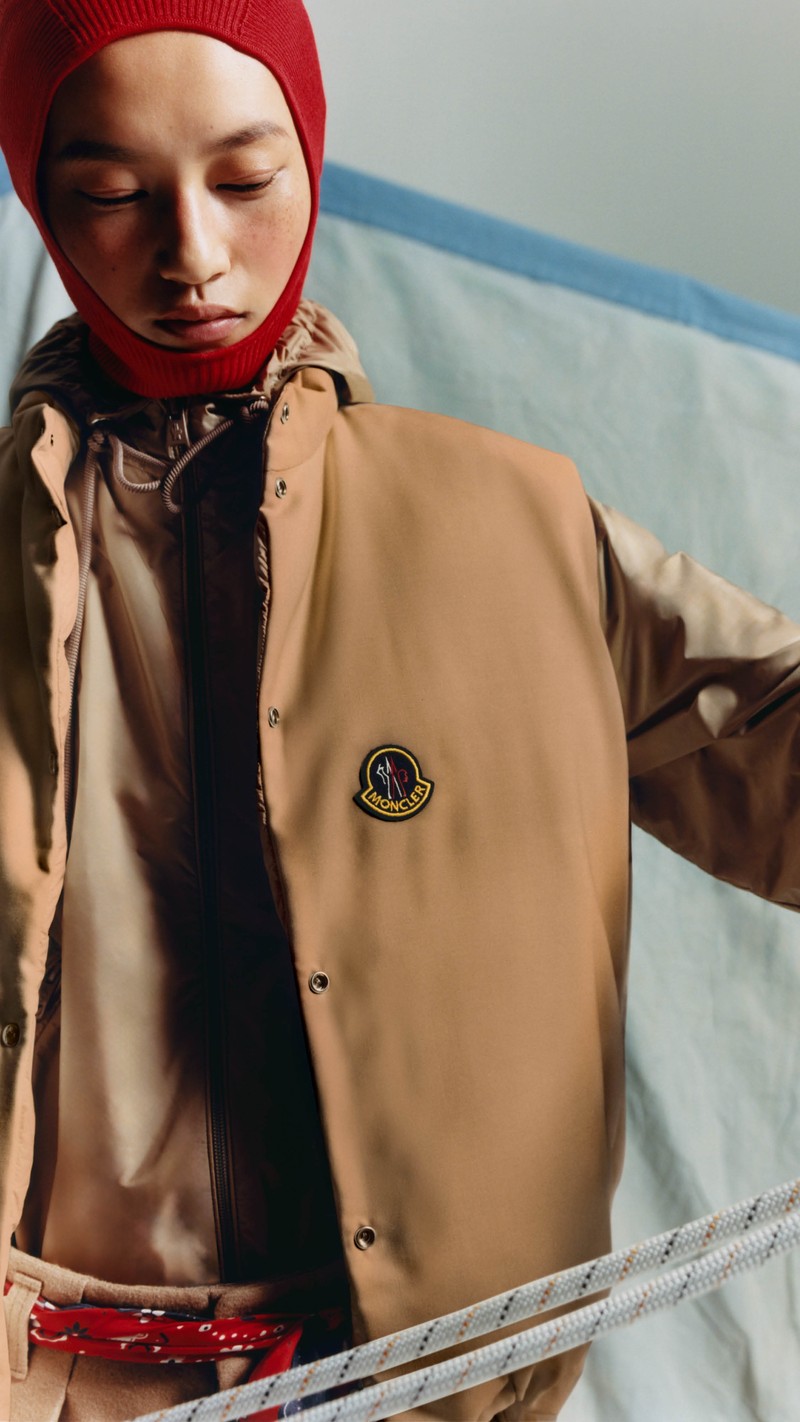 Moncler Re/Icons 2026, Tibb. Red balaclava and camel down vest over a hooded jacket.